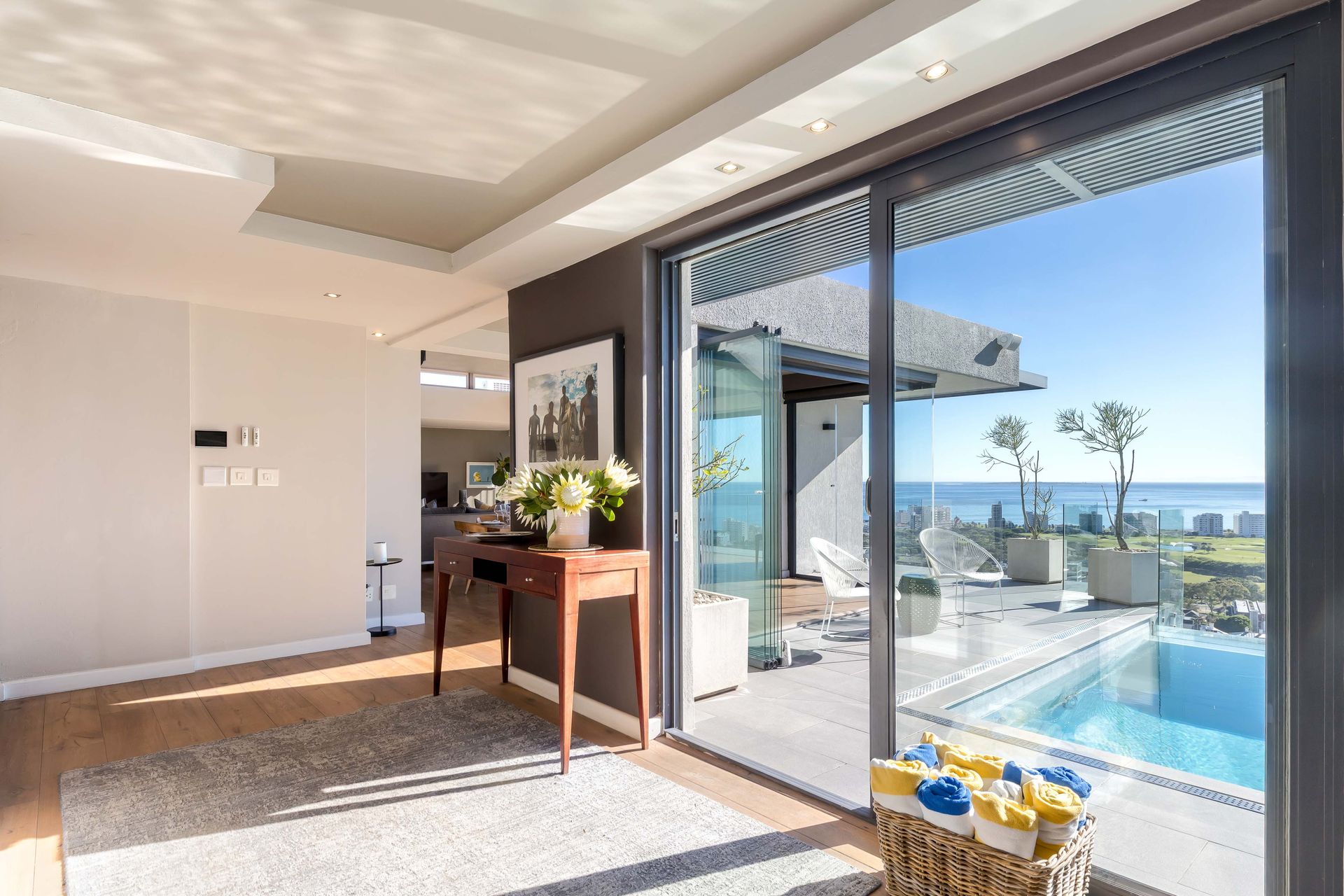 Full property management by The Hive - the entrance hall at Springbok, a luxury villa in Green Point, Cape Town, opening onto the pool terrace